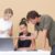 Two woman and one man looking at the laptop